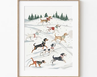 May include: A framed watercolor print featuring a winter scene with several dogs running through the snow. The dogs are various breeds and colors, each wearing a scarf or collar. Evergreen trees are in the background.