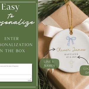 May include: White ceramic ornament with a blue bow and gold text that reads "Oliver James, Baptized 07. 11. 2025." The ornament hangs from a gold string and is on a wrapped gift.