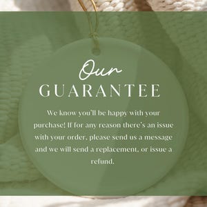 May include: A round, light green tag with the words "Our GUARANTEE" in white script and block letters. The text below states the seller's commitment to customer satisfaction, offering replacements or refunds for any order issues. The tag hangs against a textured, off-white background.