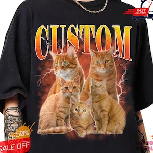 May include: A black t-shirt with the word "CUSTOM" in orange and yellow letters with a lightning bolt design. The shirt features a graphic of five orange tabby cats.