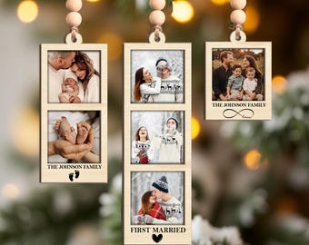 May include: Wooden photo ornaments with family photos. Each ornament has a rectangular frame with two or three photos. The text "THE JOHNSON FAMILY" and "FIRST MARRIED" are printed on the ornaments. The ornaments are hanging from a string with wooden beads.