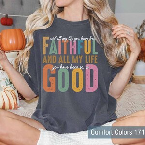 May include: A dark gray t-shirt with a colorful graphic that reads "and all my life you have been FAITHFUL AND ALL MY LIFE you have been so, so GOOD". The text is in a retro style with a distressed look.