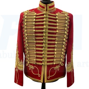 May include: A red jacket with gold trim and a high collar. The jacket has a unique design with multiple rows of gold braid.