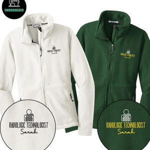 May include: Two fleece jackets, one white and one green, with a full zipper and a high collar. Each jacket has the text "RADIOLOGIC TECHNOLOGIST Sarah" embroidered on the chest. The jackets are designed for medical professionals.