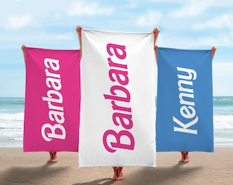 May include: Three beach towels with names printed on them. The towels are pink, white, and blue. The names are "Barbara", "Barbara", and "Kenny".