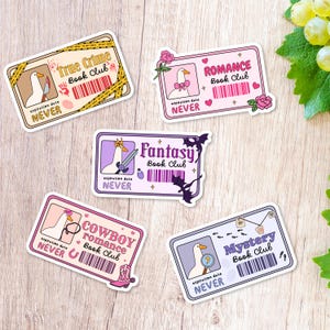 May include: Five rectangular stickers with a cartoon goose, each themed for a different book club: True Crime, Romance, Fantasy, Cowboy Romance, and Mystery. The stickers feature a barcode and the text "expiration date NEVER". The stickers have a variety of colours.