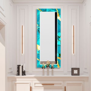 a bathroom vanity with a mirror and a vase with flowers