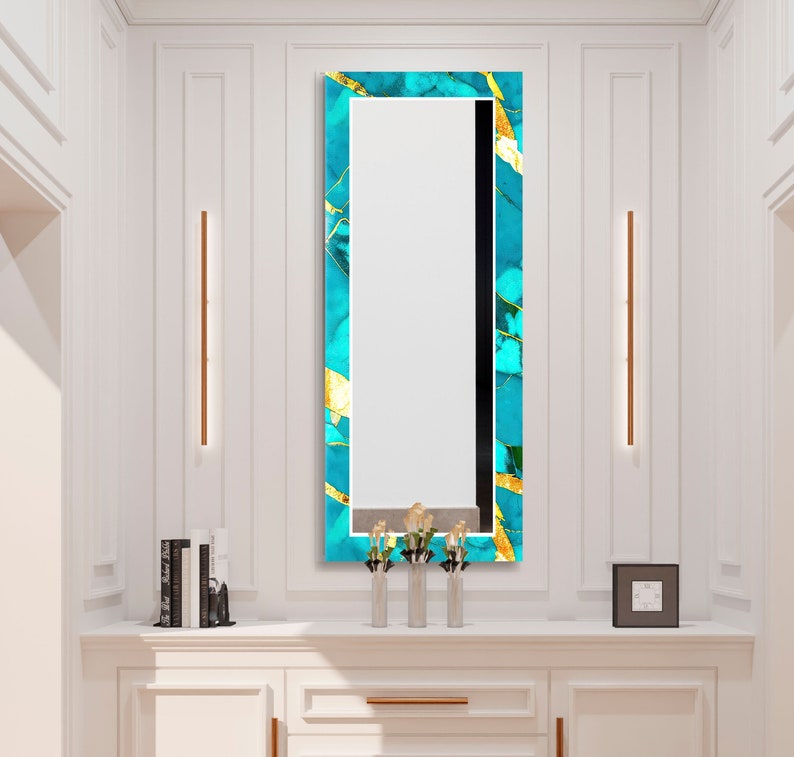 a bathroom vanity with a mirror and a vase with flowers