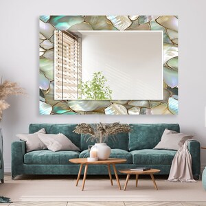 Stylish wall mirror with glossy glass frame in contemporary living space