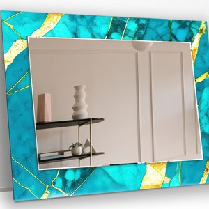 a bathroom mirror with a blue and yellow frame