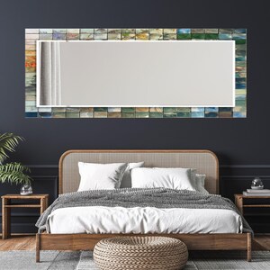 a bedroom with a bed and a mirror on the wall