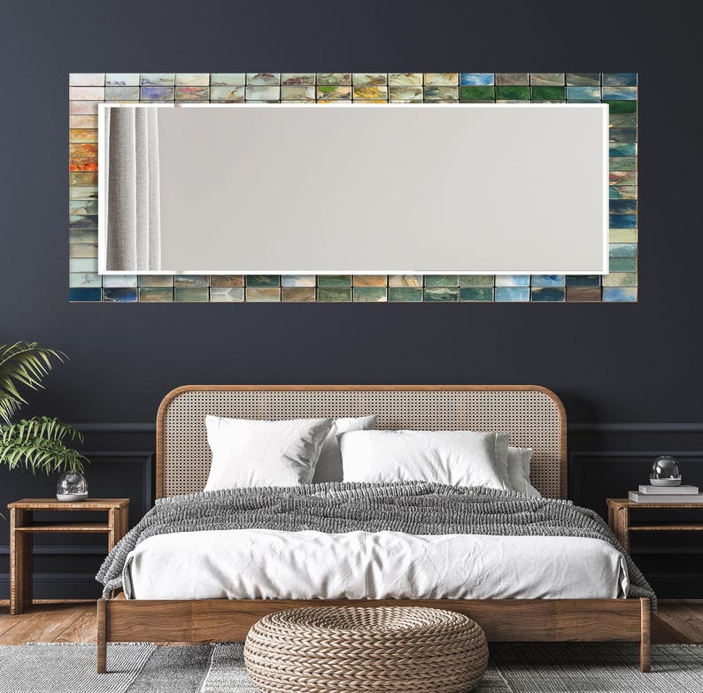 a bedroom with a bed and a mirror on the wall