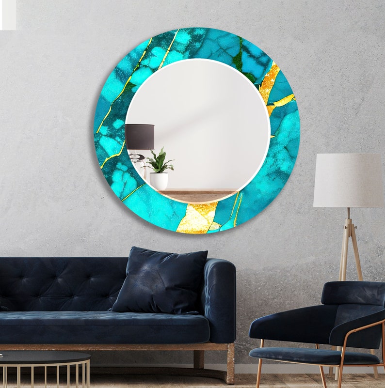 a living room with a blue couch and a round mirror