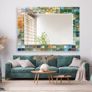 a living room with a blue couch and a mirror