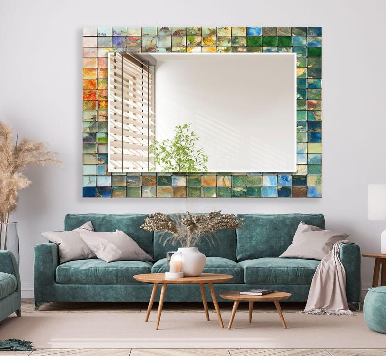 a living room with a blue couch and a mirror