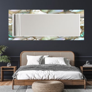 Elegant glass wall mirror with reflective pearl-inspired frame