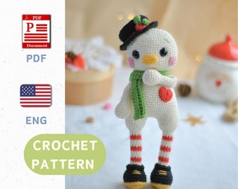 May include: Crochet pattern for a white snowman amigurumi with a green scarf, red and white striped legs, and a black top hat. The pattern is available in English and includes a PDF download.