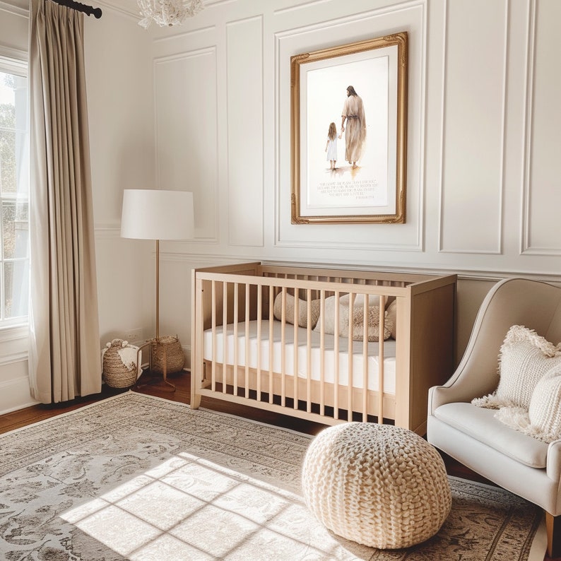 May include: A white crib with a white mattress and a white knitted ottoman in a nursery with a beige rug, a white lamp, and a framed print of a painting of a man and a girl walking.