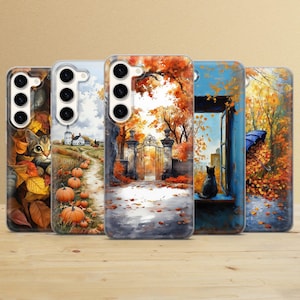 May include: Four phone cases with autumn-themed designs. The cases feature a gate, a cat, pumpkins, and a window with a cat looking out. The cases are all clear and have a white background.