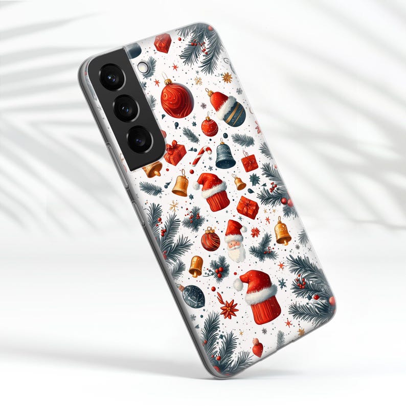 May include: A clear phone case with a white background and a Christmas-themed design. The design features red and green ornaments, Santa Claus, and pine branches.
