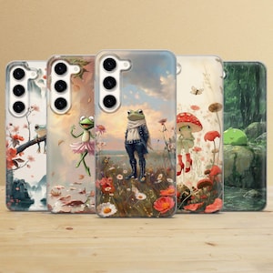 May include: Set of six phone cases featuring colourful illustrations of frogs in various poses. The cases have a clear background with a floral design. The cases are designed for a smartphone with a camera lens on the back.