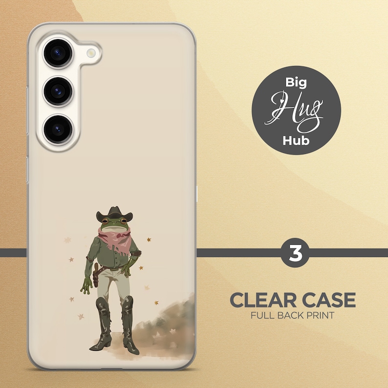K&ouml;nnte beinhalten: Eine transparente Handyh&uuml;lle mit einem vollfl&auml;chigen Druck einer Frosch, der einen Cowboyhut und ein Bandana tr&auml;gt. Der Frosch steht auf einem braunen und wei&szlig;en Hintergrund mit goldenen Sternen. Der Text "Big Hug Hub" ist in einem Kreis auf der H&uuml;lle gedruckt.
