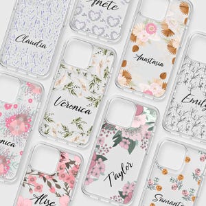 May include: Clear phone cases with floral and botanical designs. Each case features a different name in elegant script, including "Claudia," "Veronica," "Anastasia," and "Taylor." The cases showcase a variety of pastel colors, including pink, green, and lavender.