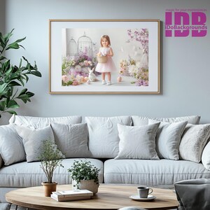 May include: A framed photograph of a young girl in a pink dress holding a basket of colorful eggs. The girl is standing in a whimsical setting with flowers, cages, and a white rabbit. The photograph is framed in a gold frame.
