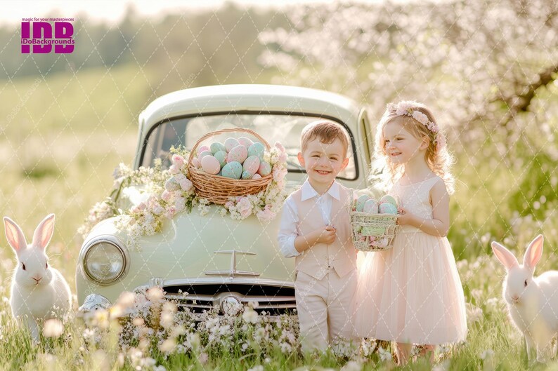 May include: Two children, a boy and a girl, stand in front of a vintage car decorated with pastel Easter eggs and flowers. The girl is wearing a pink dress and a flower crown. The boy is wearing a light brown vest and pants. Both children are holding baskets of Easter eggs.