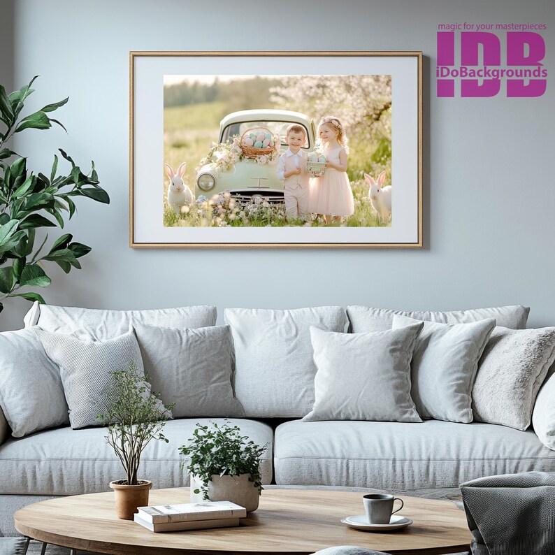 May include: Two children, a boy and a girl, stand in front of a vintage light green car with a basket of Easter eggs on the hood. The children are holding baskets of Easter eggs. The car is parked in a field of flowers. There are two white rabbits in the background.