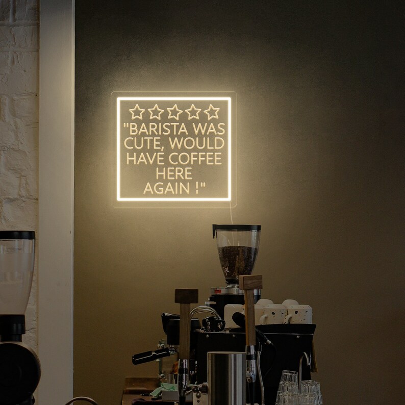 May include: A white neon sign with five stars and the text "Barista was cute, would have coffee here again!"
