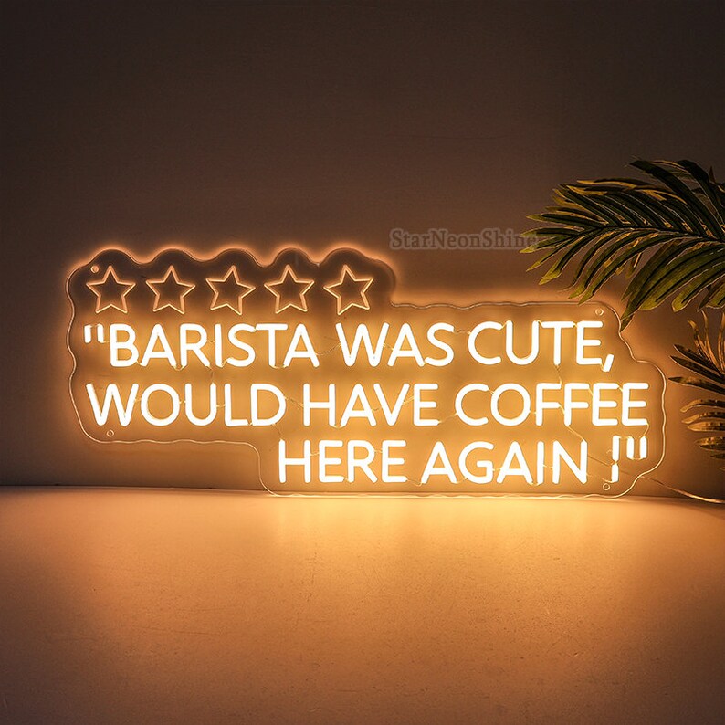 May include: White neon sign with five stars and the text "Barista was cute, would have coffee here again!"