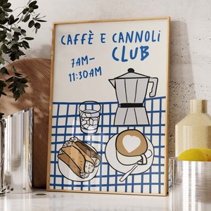 May include: A framed illustration of a cafe menu with the text "Caffe e Cannoli Club" and the hours "7AM-11:30AM". The illustration features a blue and white checkered tablecloth with a coffee pot, a glass of ice water, a plate of cannoli, and a cup of cappuccino.