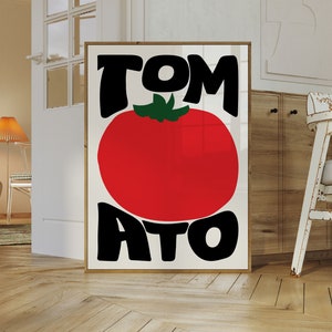 May include: A white poster with black text that says "TOMATO" with a large red tomato in the middle.