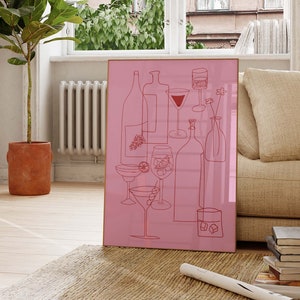 May include: A pink framed print with a line drawing of various glasses and bottles. The drawing is in red and includes a wine glass, a martini glass, a cocktail glass, and a decanter.