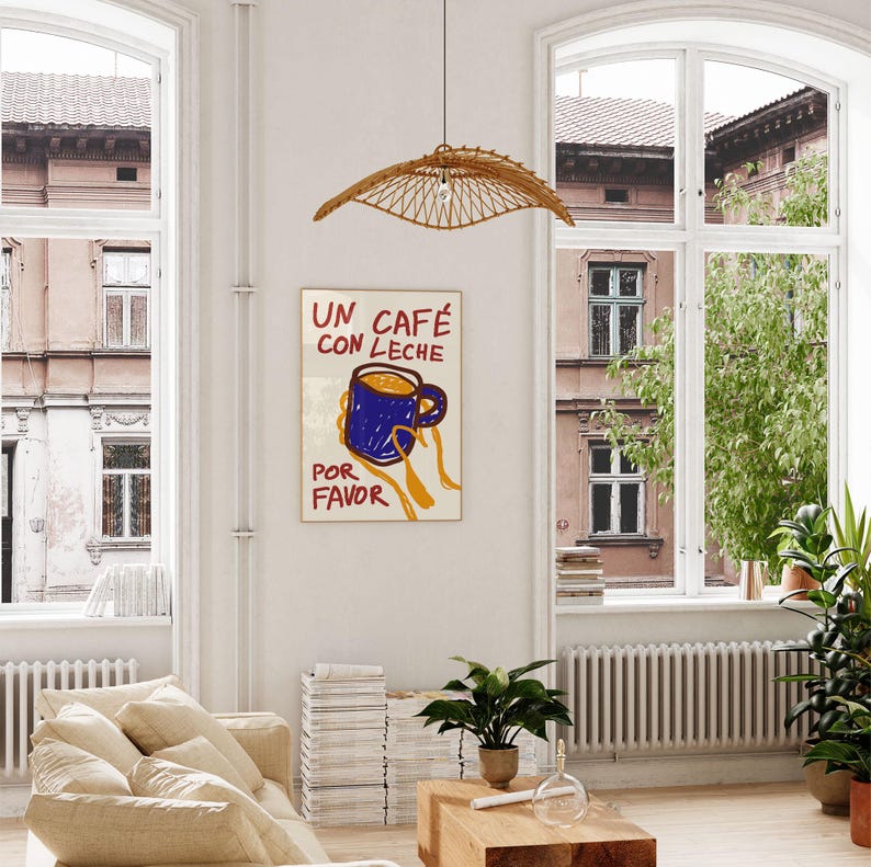 以下が含まれることがあります： スペイン語で「Un cafe con leche por favor」と書かれたカラフルなポスター。青いコーヒーカップを手に持ち、中に茶色の液体が入っています。
