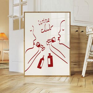 Puede incluir: Una impresi&oacute;n enmarcada blanca con dibujos de l&iacute;nea roja de dos personas bebiendo vino. El texto "wine club" est&aacute; escrito en rojo en la impresi&oacute;n.