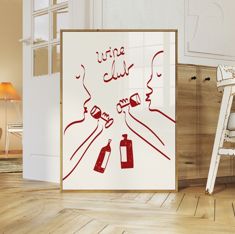 Puede incluir: Una impresi&oacute;n enmarcada blanca con dibujos de l&iacute;nea roja de dos personas bebiendo vino. El texto "wine club" est&aacute; escrito en rojo en la impresi&oacute;n.