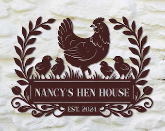 May include: A brown metal sign with a silhouette of a hen and chicks surrounded by a wreath. The sign reads "NANCY'S HEN HOUSE EST. 2024".