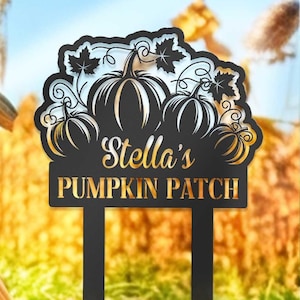 May include: Black metal pumpkin patch sign with the text "Stella's Pumpkin Patch". The sign is in a field with a large orange pumpkin in the foreground.