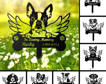 May include: A set of 10 black metal garden stakes featuring different dog breeds with angel wings. Each stake has a bone-shaped plaque with the text "In Loving Memory" and space for a name and dates. The stakes are designed to be placed in the ground as a memorial for a beloved pet.