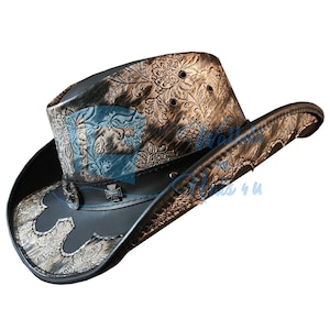 Könnte beinhalten: Ein schwarzer und brauner Cowboyhut mit einem dekorativen Blumenmuster. Der Hut hat ein Lederband mit einem Kreuzemblem und einen dekorativen Rand. Die Krone des Hutes hat ein strukturiertes Design mit einem floralen Muster.