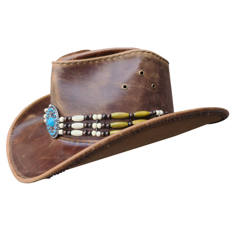 May include: A brown leather cowboy hat with a beaded band and a turquoise stone embellishment.