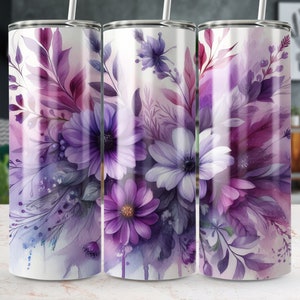 Op de afbeelding: Drie roestvrijstalen bekers met een paars en wit bloemenmotief. De bekers hebben een witte achtergrond met een aquareleffect.