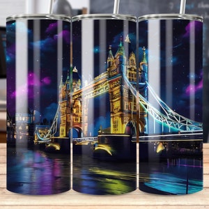 May include: A stainless steel tumbler with a colorful image of the Tower Bridge in London at night. The bridge is lit up with colorful lights and the sky is a dark blue with purple and pink clouds.
