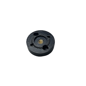 May include: Black plastic 3D printed gear with a brass threaded insert in the centre.