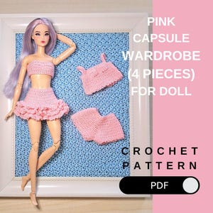 May include: A doll wearing a pink crochet outfit, including a top and skirt, with additional matching pieces. The image includes the text "PINK CAPSULE WARDROBE (4 PIECES) FOR DOLL" and "CROCHET PATTERN PDF". The doll is displayed in a white frame.