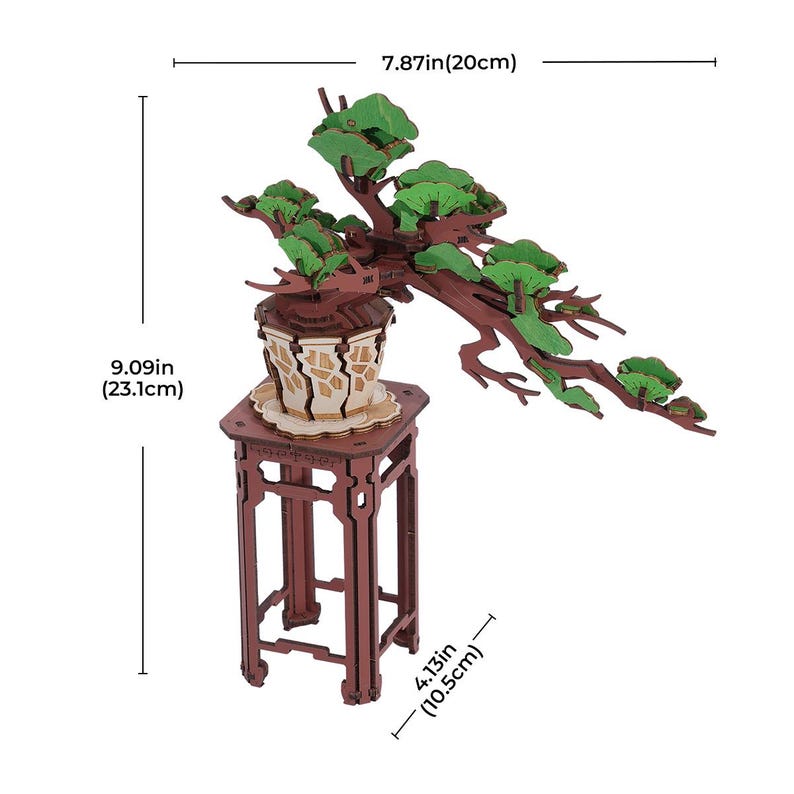 May include: A wooden model of a bonsai tree with green leaves, sitting on a brown wooden stand. The tree is 7.87 inches (20 cm) tall and the stand is 4.13 inches (10.5 cm) tall.