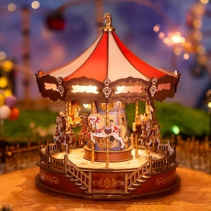 May include: A wooden carousel with a red and white striped roof, gold accents, and four horses. The carousel is lit up with small lights and has a whimsical, vintage aesthetic.
