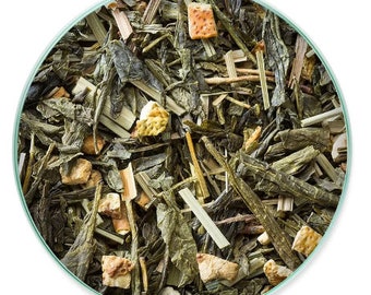 May include: A close-up of a green tea blend with dried orange peel and lemongrass. The tea is loose leaf and ready to be brewed.
